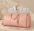 Bolsa de viaje plegable rosa, abierta con una camisa colgada